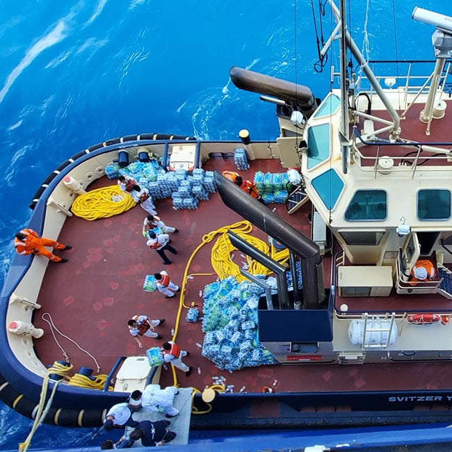 Thousands of Bottles of Water Being Loaded onto a Tug From Celebrity Equinox