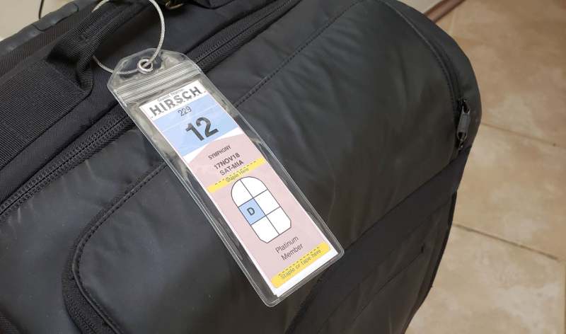 Suitcase with Bag Tag in Luggage Tag Holder - Ready to be Checked 