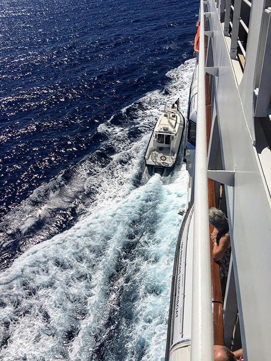 A pilot boards Oceania Sirena in New Caledonia on Oceania Sirena. This fascination must run in the family.