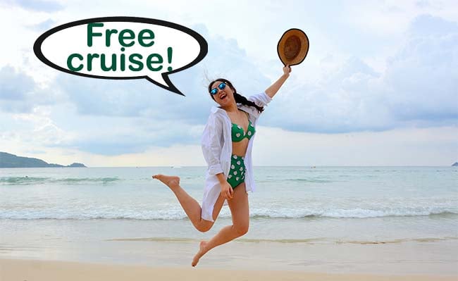 Woman jumping on beach after getting a free cruise