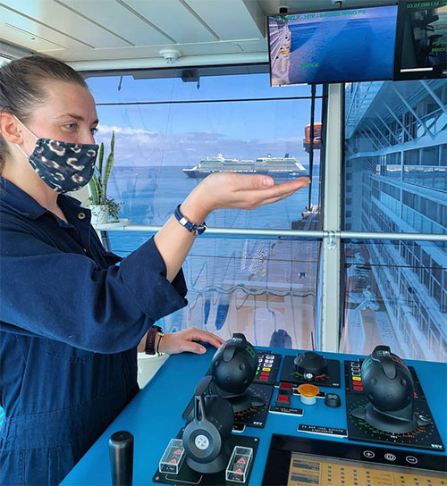 Officer on the bridge of Celebrity Edge Wearing Mask