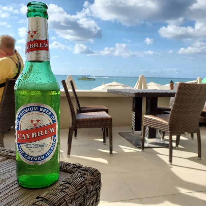 Enjoying a Local Beer at Royal Palms Beach Club in grand Cayman